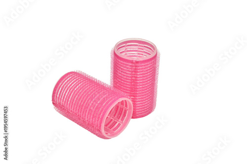 Pink Velcro hair curlers isolated on white background.
