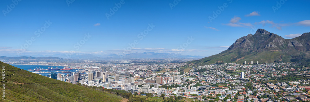 Fototapeta premium Mountains, ocean and city with environment, landscape and location for tourism, banner and blue sky. Empty, outdoor and natural beauty with hills, beach and destination for summer holiday and space