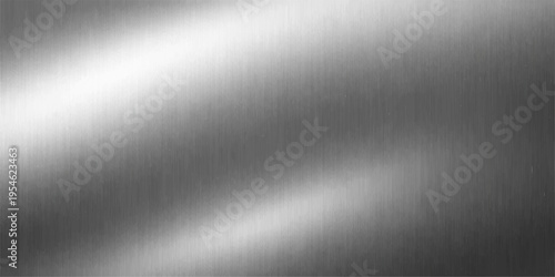 A polished brushed metal plate texture featuring a shiny silver stainless steel surface with an industrial gray metallic pattern and light reflections on a seamless aluminium backdrop material
