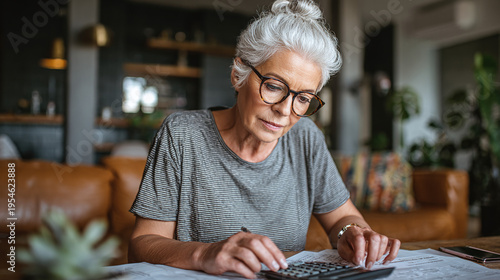 senior woman planning retirement annuity in cozy living room while managing financial paperwork and calculator for pension income budgeting and long term money security