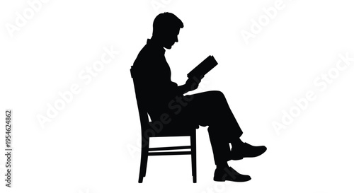 A man sits and reads a book in a striking silhouette
