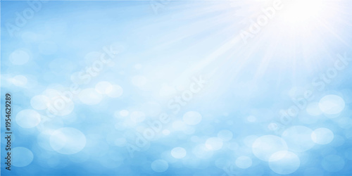 Beautiful blue abstract background featuring fluffy white clouds and bright summer sunlight across a clear sunny sky