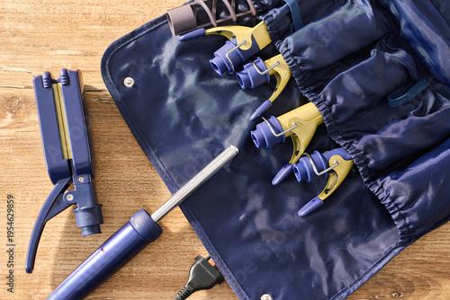 Photos Tools and equipment for hairstyling are arranged on a wooden surface beside a ca
