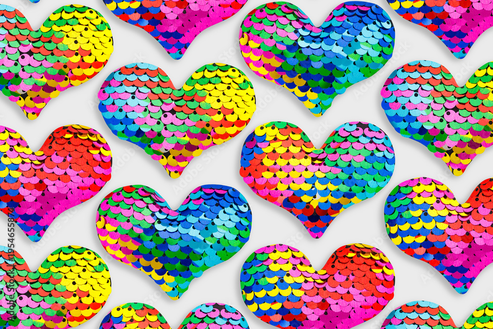 Fototapeta premium Colorful glittering hearts pattern, love symbol of sparkling sequins rainbow colors, trend repeated layout from toys shape heart, creative romance holiday design, festive Valentine designs wallpaper.