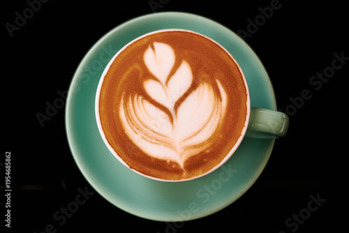 Minimalist coffee cup with latte art on dark background