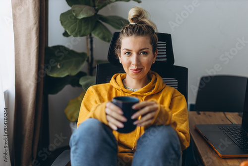 Calm woman resting with coffee in home office showing emotional recovery and self care after burnout in remote work lifestyle