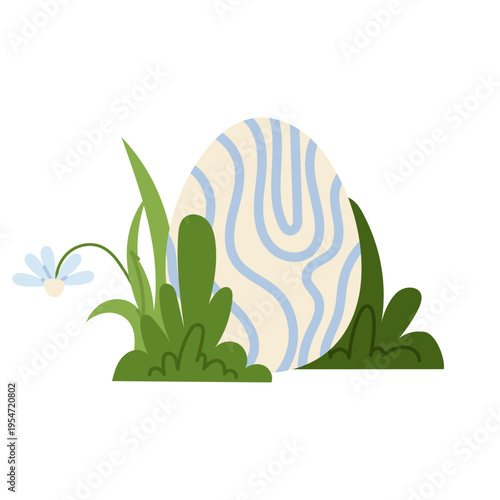 Decorative Easter egg with abstract pattern placed in green grass. Bright spring element for holiday designs, greeting cards and seasonal decorations.