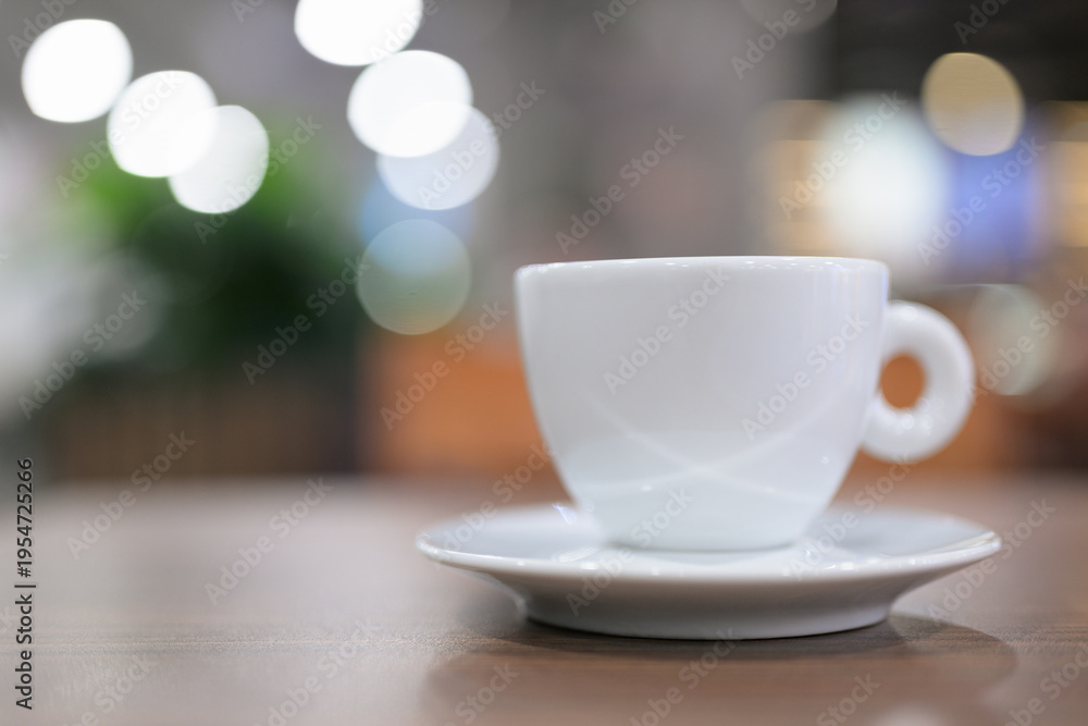 Fototapeta premium White Espresso Cup on Wooden Table with Bokeh Background