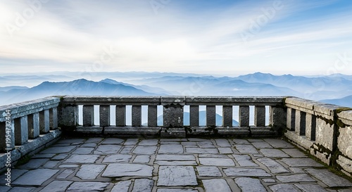 Stone balcony overlooking a misty mountain landscape at sunrise