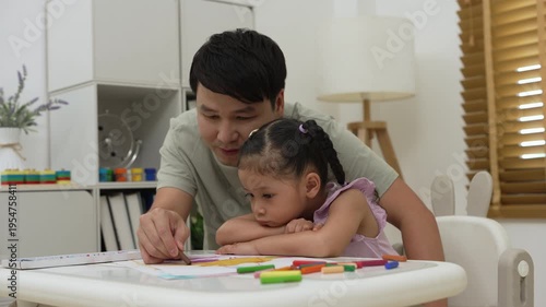 father and child girl drawing and painting with colorful oil pastels on paper at home