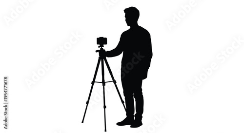 Silhouette of a man operating a tripod mounted smartphone camera for video creation.