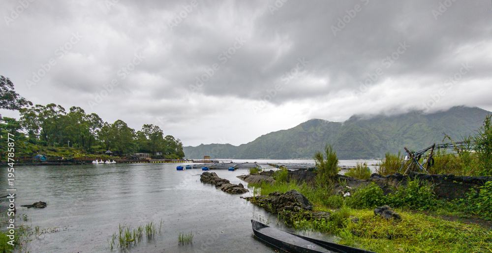 Fototapeta premium Overcast sky hangs low above calm waters