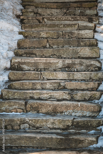 Foto Stone steps descending outdoors, partially covered with white snow and slippery