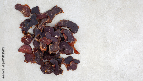 Εκτύπωση καμβά Sliced biltong dried beef snack on grey background with copy space