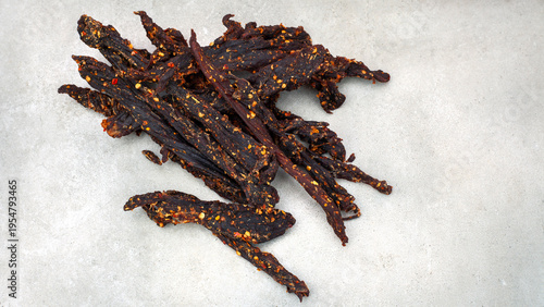 Pile of spicy biltong dried beef snack with chili seasoning