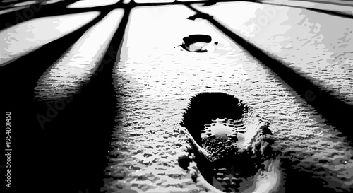 Dramatic black and white image of footprints in freshly fallen snow with stark shadows casting across the textured surface