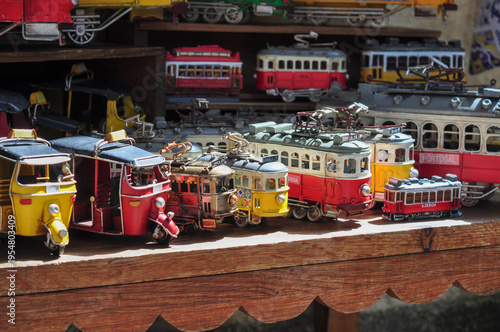Colorful vintage-style Portuguese tram souvenirs on a wooden market stall