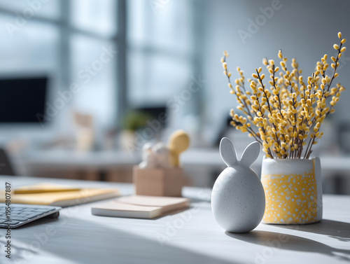 White bunny egg ornament and yellow catkins in a vase on desk easter day