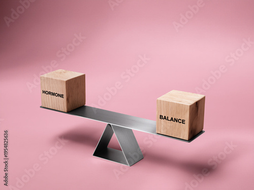 modern simple fulcum scales with two wooden block, visually showing the imbalance in using the words Hormone balance embossed one word one each block