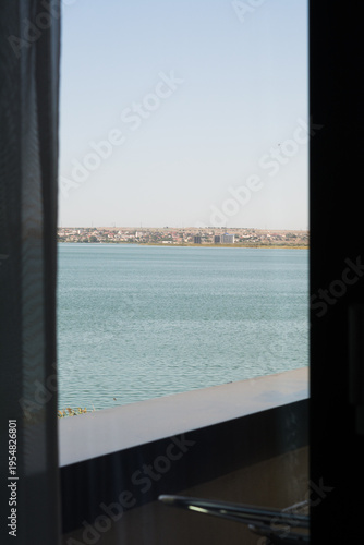 View of the lake through a closed PVC window