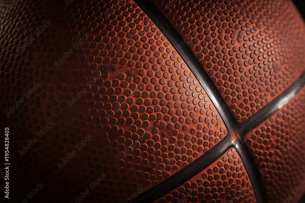 Obraz premium Close-up of Orange Basketball Surface with Blue Lines and Textured Pattern