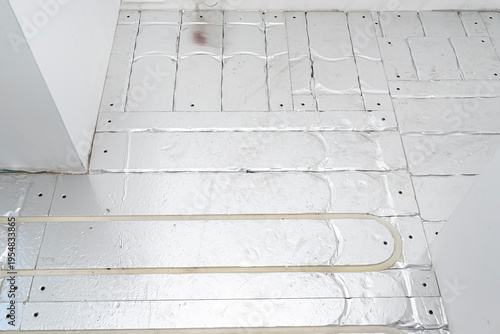 Fotografie Underfloor heating system pex pipe installation on floor insulation