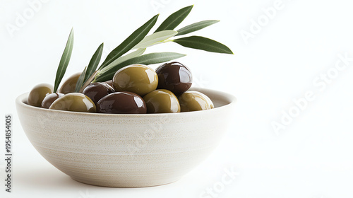 Glossy Green and Brown Olives in Ceramic Bowl with Olive Leaves