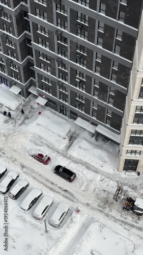Winter city residential buildings with parked cars and snow urban life and real estate concept