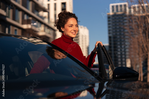 Woman enjoying a city car ride at sunset