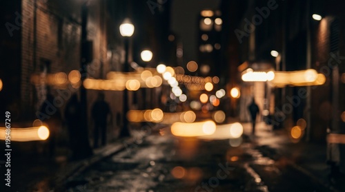 Blurry city street at night with people walking.