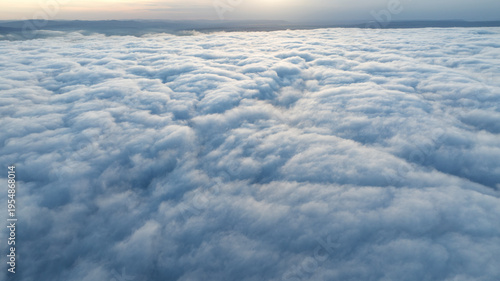 Aerial view sunset sky over clouds drone shot. White cloud layer texture. Scenic natural phenomenon high altitude photography environment scenery background clear horizon