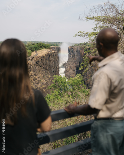 woman exploring victoria falls with guide