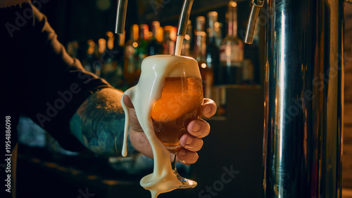 Cuadro en lienzo Close up of draft beer glass with thick foam spilling over bartender hand in pub