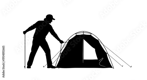 Silhouette of a Camper Setting Up a Tent Outdoors