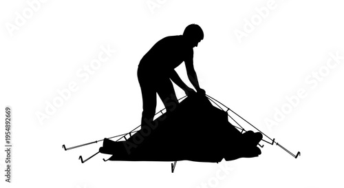 Silhouette of a Person Setting Up a Camping Tent