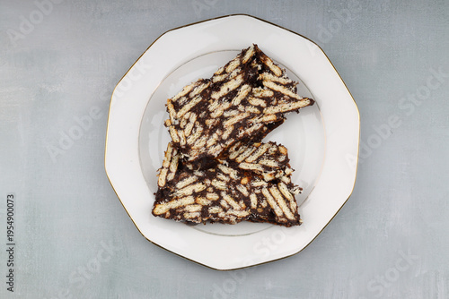 Two Slices of Homemade Chocolate Mosaic Cake with Biscuits on a Plate