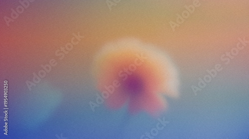 Abstract floral image with soft focus and gradient colors creating a dreamy atmosphere, featuring a blurred flower shape against a colorful background