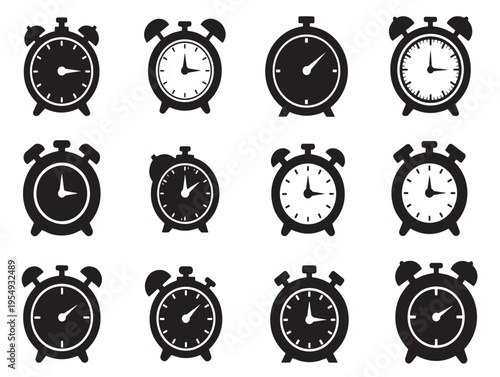 A collection of black and white alarm clocks