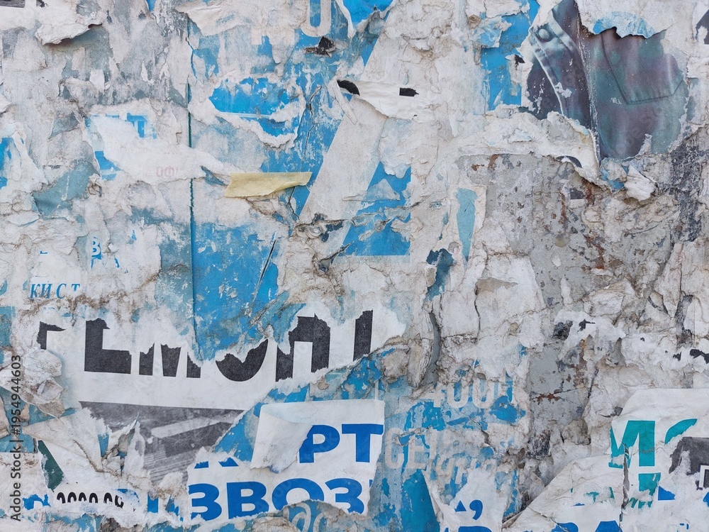 Fototapeta premium Torn and ripped street poster background, messy and old weathered paper details