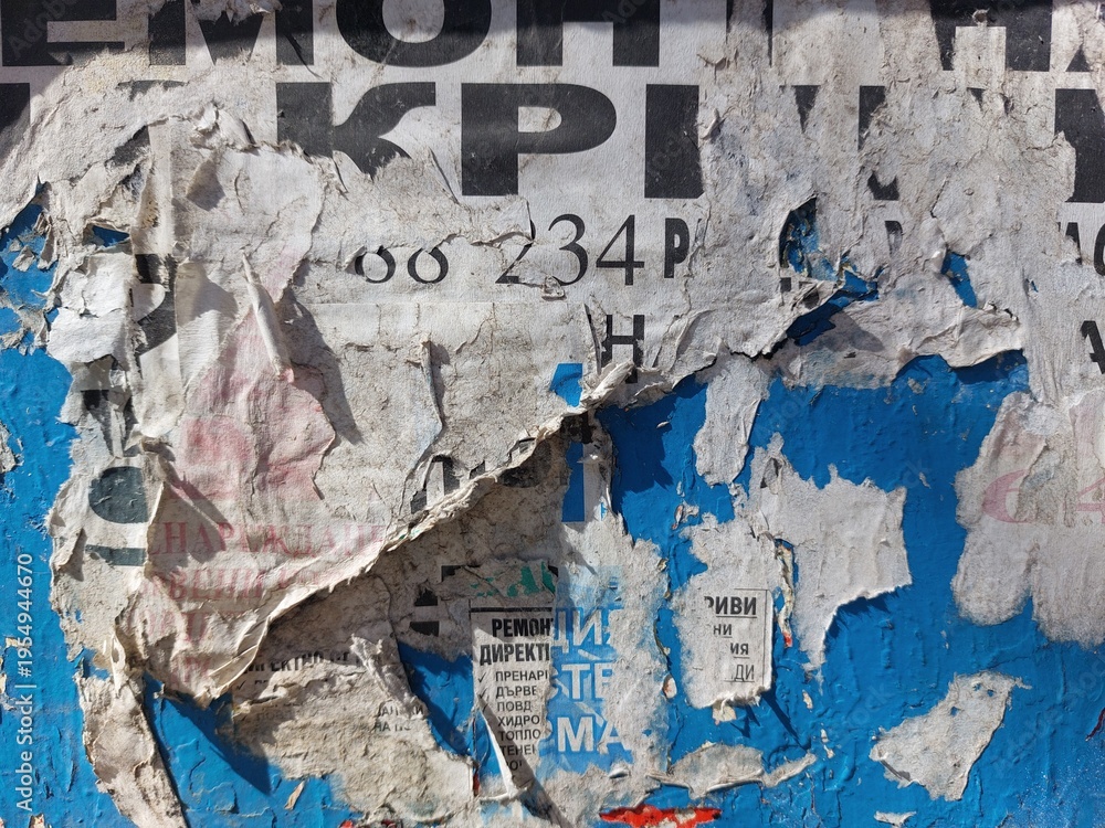 Fototapeta premium Torn and ripped street poster background, messy and old weathered paper details
