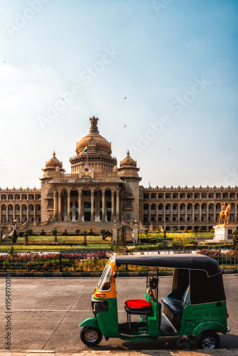 Auto Rickshaw, highly used public transport passing near Vidhana Soudha building