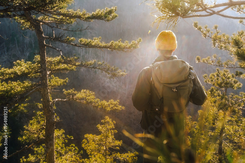 Male Hiker with Backpack in Sunset Pine Forest