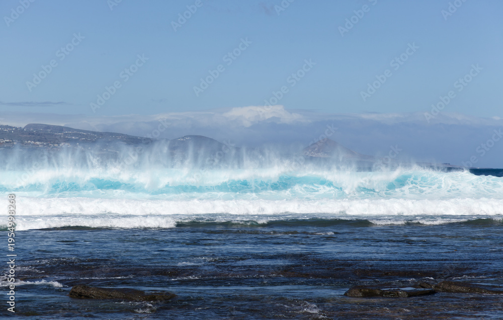 Naklejka premium Gran Canaria, view towards Atlantic ocean from El Confital beach on the edge of Las Palmas de Gran Canaria, big waves crushing