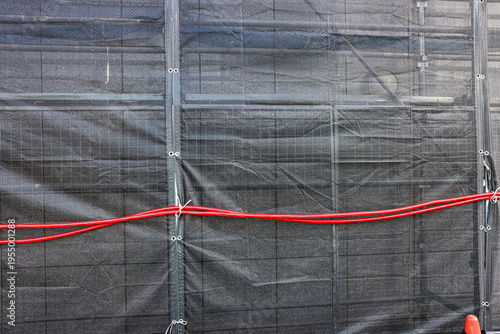 Covered facade of a reconstruction building, Scaffolding with safety nets during renovation building.