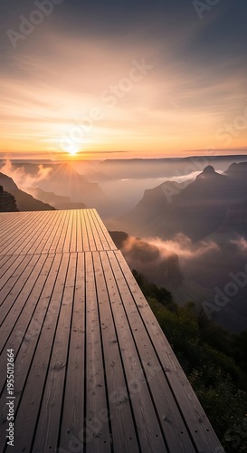 Wooden deck overlooking the Grand Canyon at sunrise with misty clouds