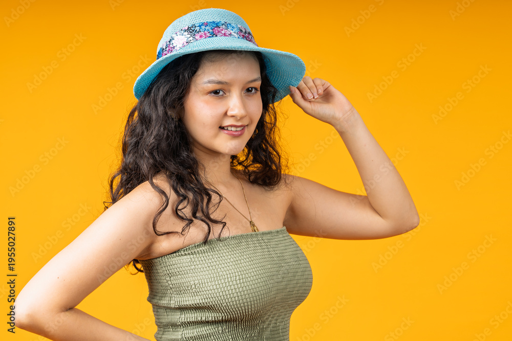 Fototapeta premium Young woman wearing blue hat smiling outdoors