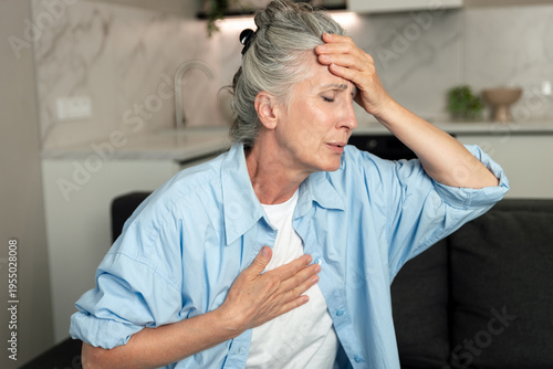 Quadro su tela Woman experiencing chest pain and weakness in living room during cardiac distres