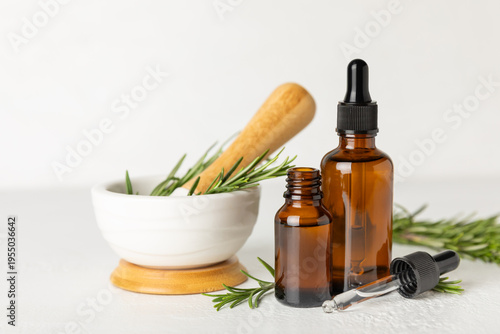 Foto Rosemary essential oil on a textured background