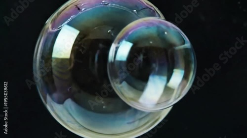 Abstract visualization of numerous translucent bubbles of different scales gently colliding and separating in a serene, weightless environment. Illustrating the delicate interplay of spheres in a?