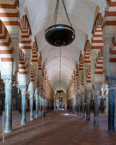 Iconic columns and arches inside Mezquita Mosque Cathedral in Cordoba, Spain